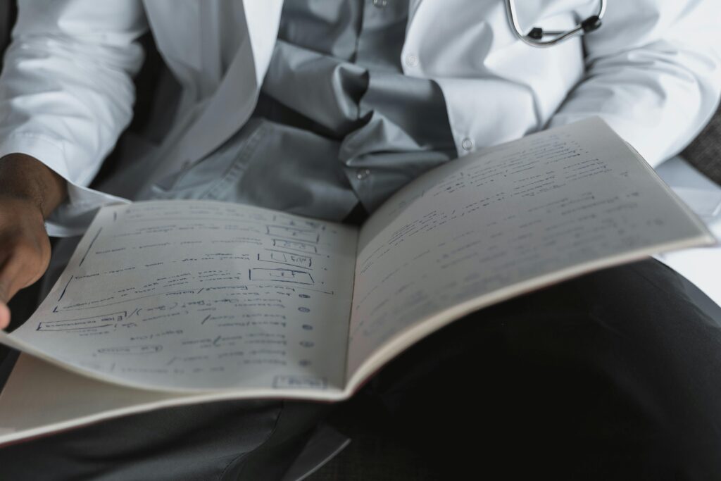 Person in White Dress Shirt Reading Book